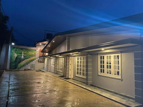 a building with a row of windows at night at Astoria Cottage in Nuwara Eliya