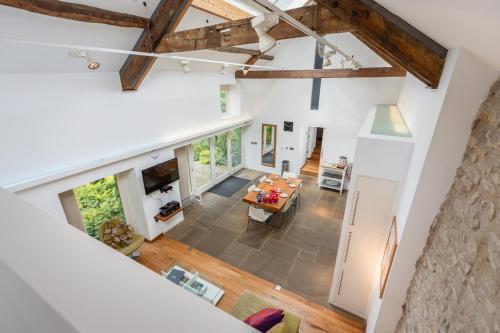 an overhead view of a living room with white walls and wooden beams at The Barn at Noelles Cottages in Pickering