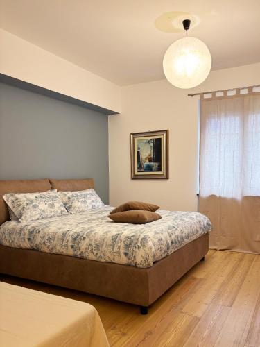 a bedroom with a bed and a light fixture at Parirolo B&B in Tresivio