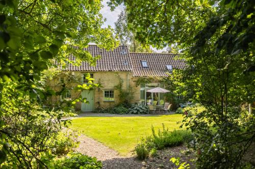an exterior view of a house with a yard at The Coach House at Noelles Cottages in Pickering