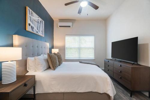 a bedroom with a bed and a flat screen tv at Landing Spectacular 1BD Clubhouse Gym in Charlotte