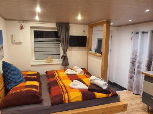 a bedroom with two beds and a window at Apartment Altenhof in Altenhof