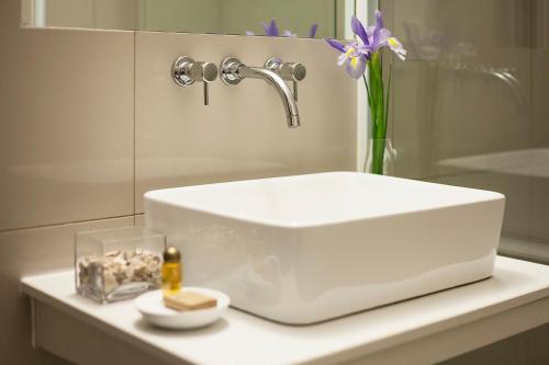 a white sink sitting on a counter in a bathroom at El Angolo in Lima