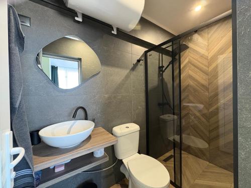 a bathroom with a sink and a toilet and a mirror at Atelier SkyLine in Gabrovo