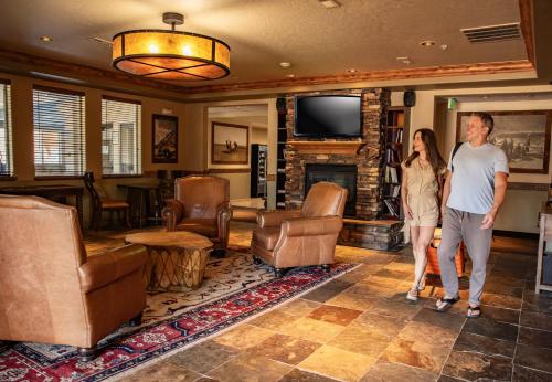 a man and a woman standing in a living room at Yellowstone Park Hotel in West Yellowstone