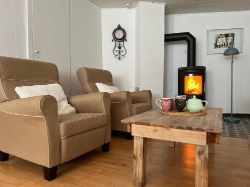 a living room with a table and a fireplace at Ferienhaus Mauseloch in Kaub