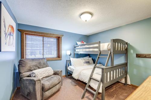 a bedroom with a bunk bed and a chair at Crystal Mountain Resort Cabin: Golf, Hike, Swim! in Thompsonville