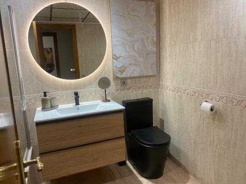 a bathroom with a sink and a mirror at Avenida Mare Nostrum 7 Patacona Beach Breakfast items in the home in Valencia