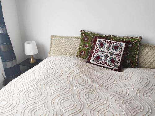 a bed with two pillows on top of it at Golden Home Törökbálint in Törökbálint