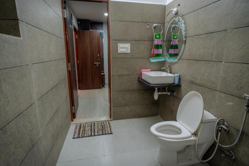 een badkamer met een toilet, een douche en een spiegel bij The Heritage in Jodhpur