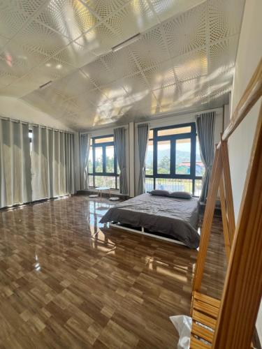 a bedroom with a bed in a room at Mia Homestay and Coffee in Bảo Lộc