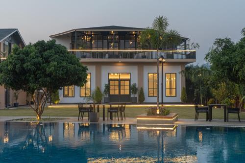 een huis met een zwembad voor een huis bij TRIDEUS THE WILD FRASER Corbett in Rāmnagar