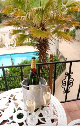 a bottle of champagne in a bucket on a table at Lakehouse Bed and Breakfast in Canyon Lake