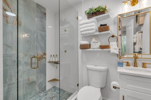 a bathroom with a shower and a toilet and a sink at La Barra #101 in St. Pete Beach