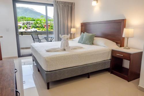 a bedroom with a bed with a towel on it at Hotel Arenal by Regina in Fortuna