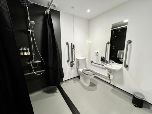 a bathroom with a toilet and a sink at The Base Camp Hotel, Nevis Range in Fort William