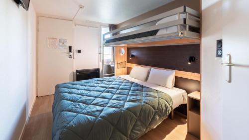 a small room with a bed in a room at Premiere Classe Valenciennes Ouest Petite Foret in Petite Forêt