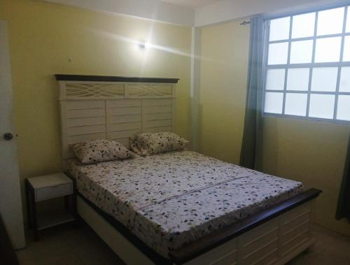 a bedroom with a bed and a window at J's vacation home in Wallhouse