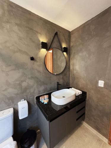 a bathroom with a sink and a mirror on a counter at Mandacaru Encantado in Miguel Pereira