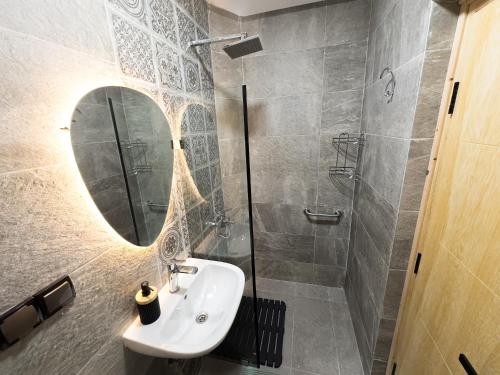 a bathroom with a sink and a mirror at Agadir Gardens Center Hotel in Agadir