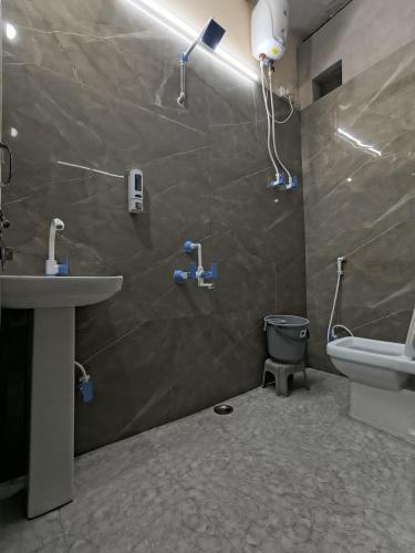 a bathroom with a sink and a toilet and a shower at The Street Homestay-600m from Taj Mahal in Agra