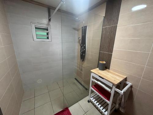 a shower with a glass door in a bathroom at Ti' case la plaine in La Plaine des Palmistes