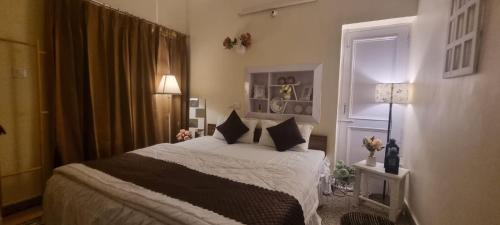 a bedroom with a bed and a window at The Moonvale Cottage A Victorian Theme Independent Homestay! in Chandīgarh