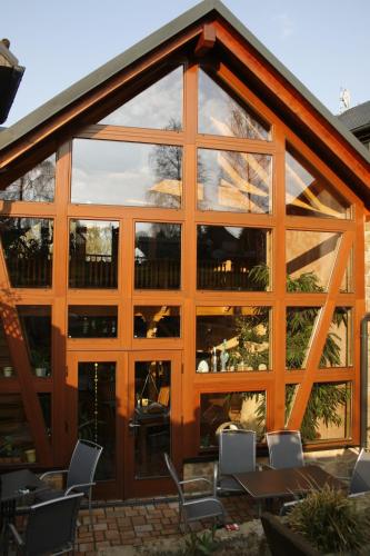 a building with large glass windows and chairs at Landhotel "Lichte Aue" Lichtenau in Stützengrün