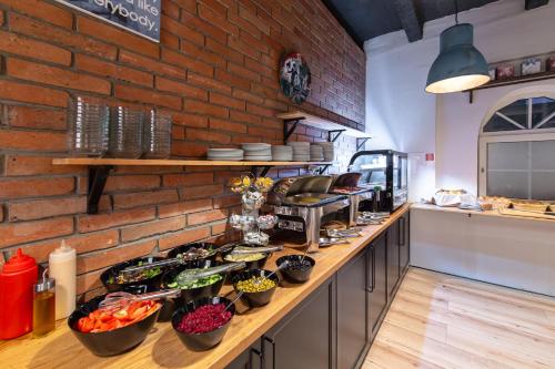 a kitchen counter with bowls of vegetables on it at 7Days B&B in Bratislava