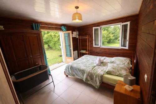 a bedroom with a bed and a window at Ti' case la plaine in La Plaine des Palmistes