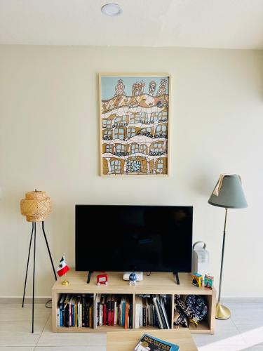 a flat screen tv sitting on top of a wooden entertainment center at Mexico City, your Hub in coyoacán in Mexico City