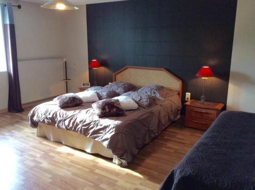 a bedroom with a bed with two pillows on it at Gîte De L'Etot Fossey in Marchésieux
