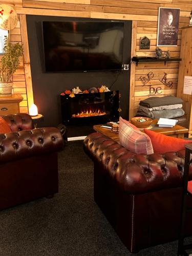 a living room with a couch and a fireplace at Shropshire Guesthouse in Wolverhampton