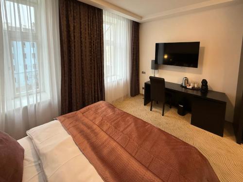 En eller flere senge i et værelse på City Central Krakovska Residence