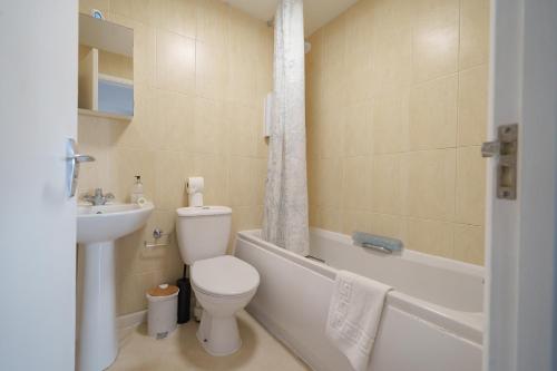 a bathroom with a toilet and a tub and a sink at Oxford Modern Living - Free Parking in Oxford