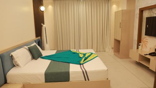 ein Hotelzimmer mit einem Bett, auf dem eine Tasche liegt in der Unterkunft hotel ashirwad in Jāmb