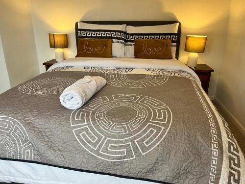 a bedroom with a bed with two towels on it at Double Room with Garden View at Love & Peace Petts Wood in Orpington