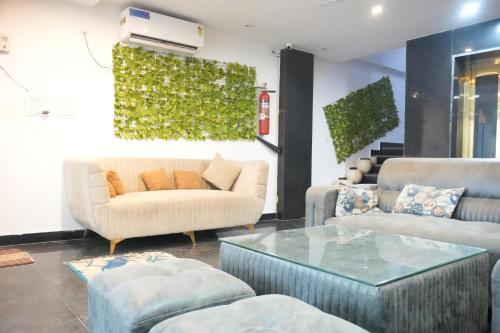 a living room with a couch and chairs and a table at Sufi Stay in Rishīkesh