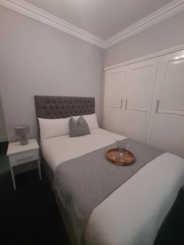 a bedroom with two beds with a tray on it at The Alexander in Whitley Bay