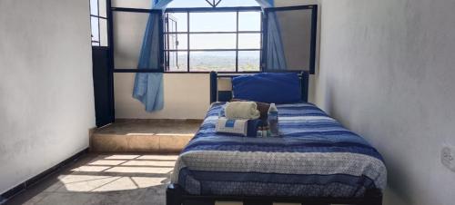 Postel nebo postele na pokoji v ubytování Hotel y Cabañas El Taxho