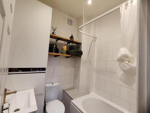 een witte badkamer met toilet en ligbad bij Accommodation Tunbridge wells in Royal Tunbridge Wells