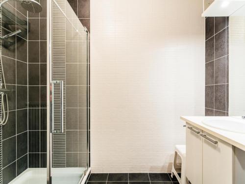 a bathroom with a shower and a sink at Le Penthouse in Koksijde