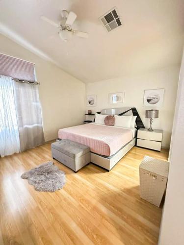 a bedroom with a bed and a wooden floor at 3BR - 3BA w Pool & BBQ -15 Mins to Strip & Airport in Las Vegas