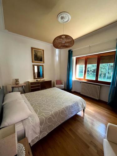 a bedroom with a bed and two windows at Villetta la Fortezza Oasi Verde e Relax Toscano in Radicofani