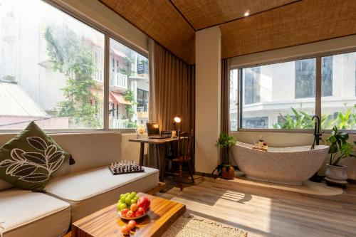 a living room with a large window and a tub at PINhome - PIN Boutique Stays in Ho Chi Minh City