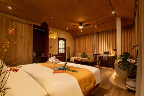 a hotel room with a bed and a living room at PINhome - PIN Boutique Stays in Ho Chi Minh City