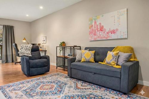 a living room with a couch and a chair at Comfy, Cozy, Central Calgary, 2BR and 1BTH in Calgary