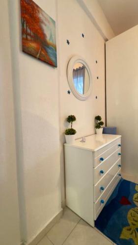 a bathroom with a sink and a mirror at Fay's paradise in Polychrono