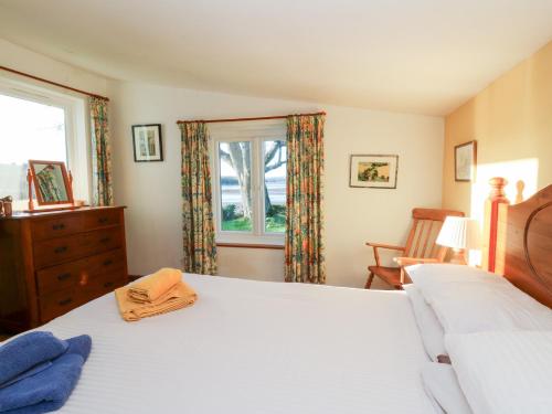a bedroom with a bed and a window at Bryncyn in Newport