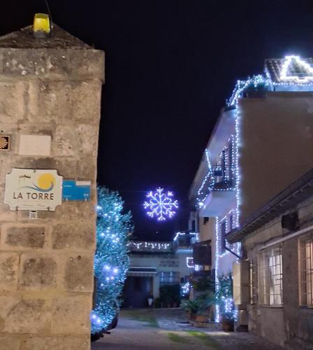 a city street with christmas lights on the buildings at La Torre in Tarquinia